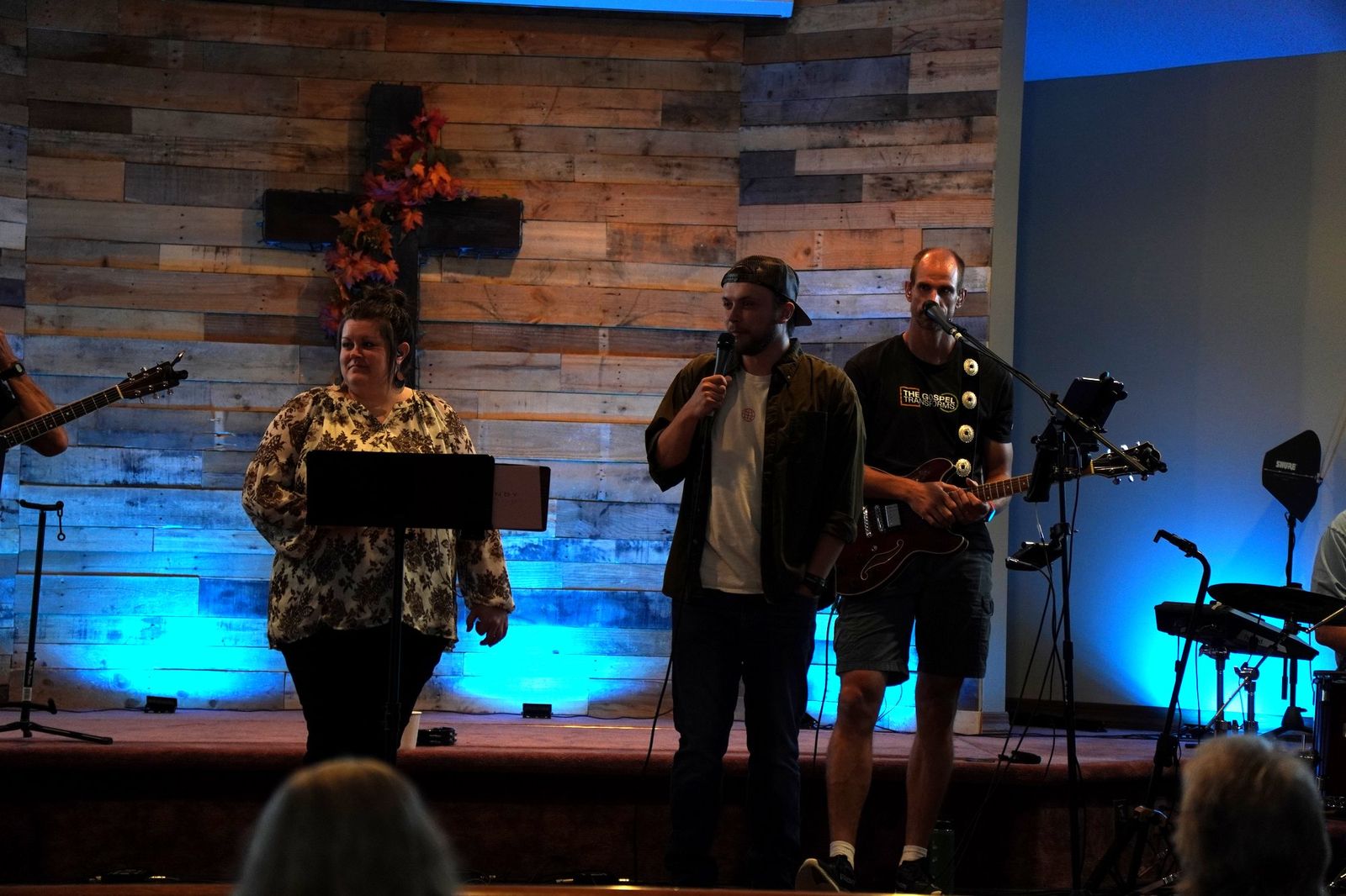 Vocalists and the band leading worship beneath the cross